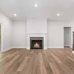 Family Room - Looking Directly at Fireplace Slider and Owner Suite Entry - DSC06033